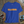 Blue t-shirt with 'CLASSIC' text on a wooden surface with vintage items.
