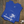 Blue t-shirt with a palm tree and beach design on a wooden surface