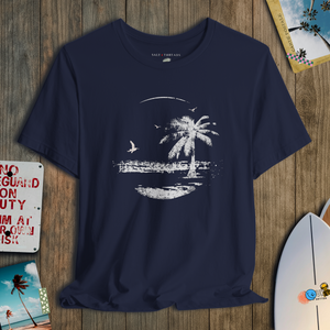 Navy blue t-shirt with a white palm tree design on a wooden surface
